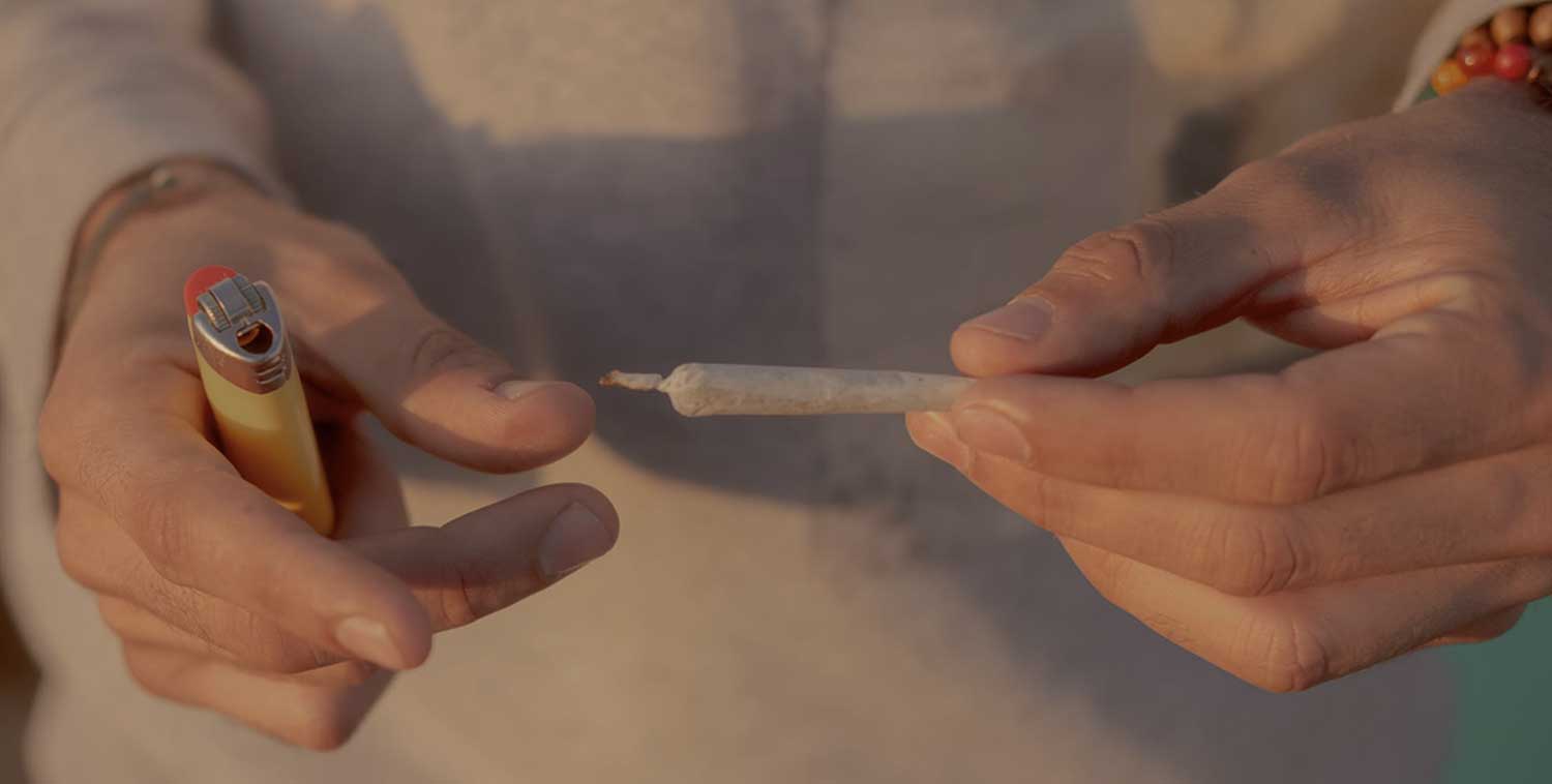 weed joint and lighter in hand